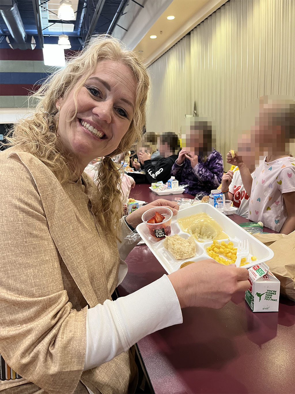 Megen visiting students during school lunch