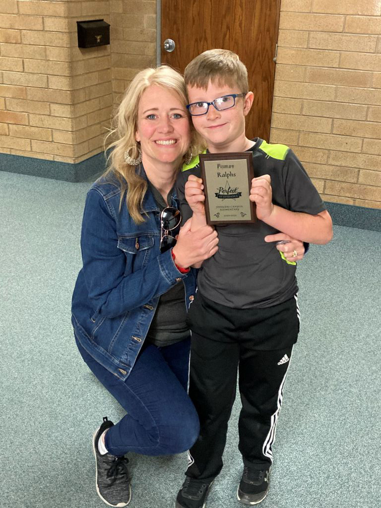 Megen with her son, honored for perfect attendance